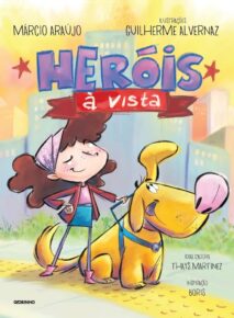 Capa de Heróis à Vista, de Márcio Araújo e Guilherme Alvernaz. A capa é colorida, e traz a ilustração de um cão guia e uma menina cega, ambos sorrindo.
