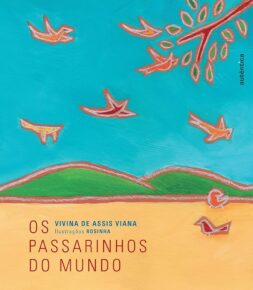 Capa de um dos livros infantis, Os Passarinhos do Mundo, de Vivina de Assis Viana e Rosinha. O livro tem o desenho de uma paisagem, com montanhas, e pássaros voando em um céu azul.